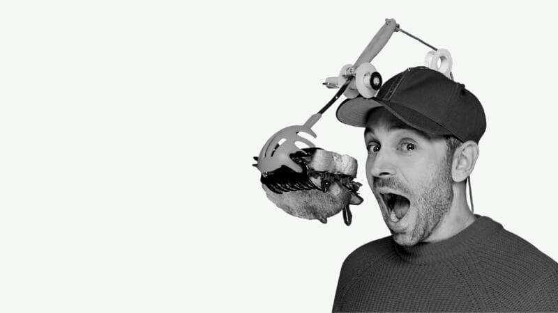 image of man eating sandwich on microphone stand