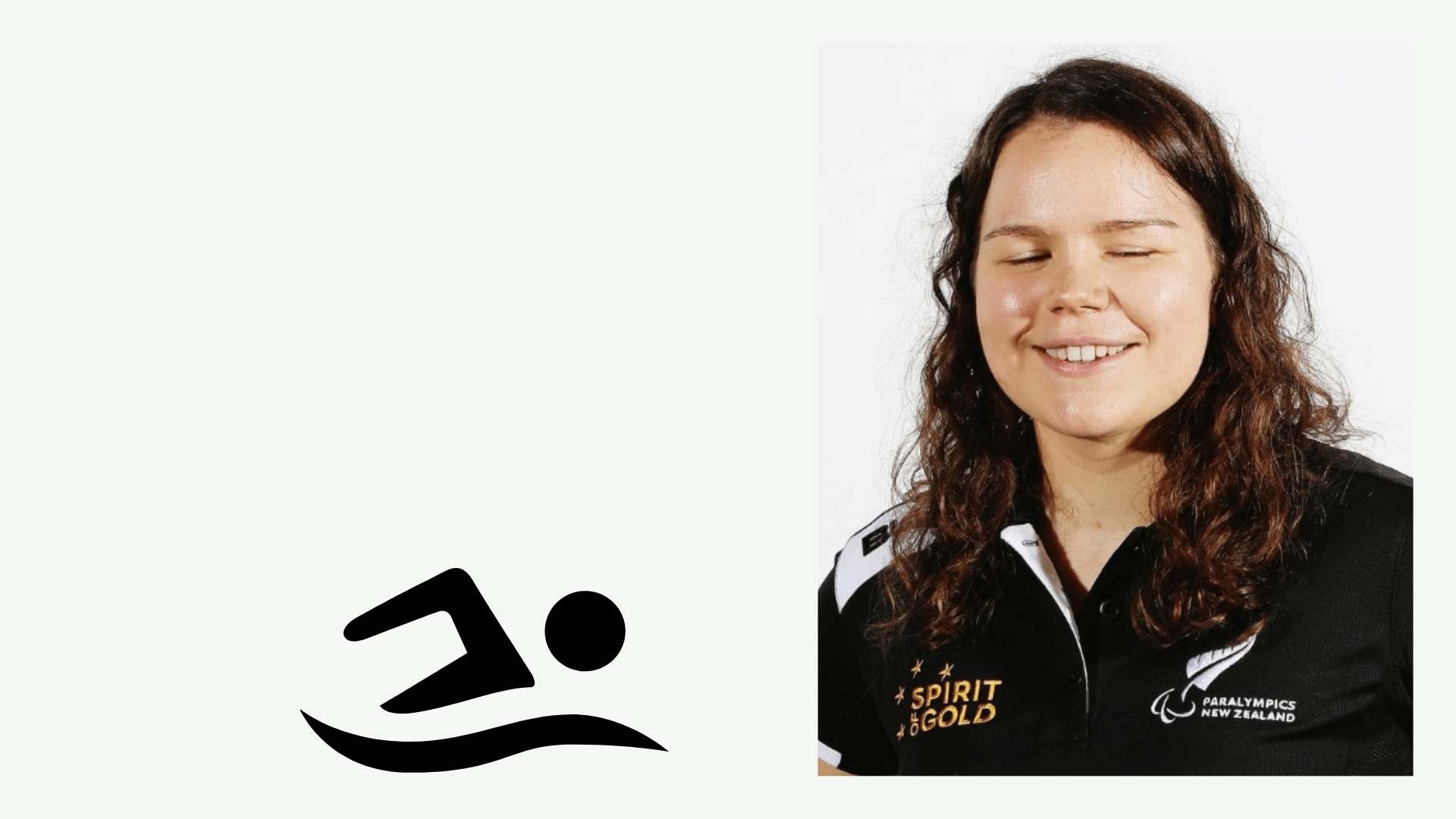 Mary Fisher wears her Paralympics NZ shirt and smiles.